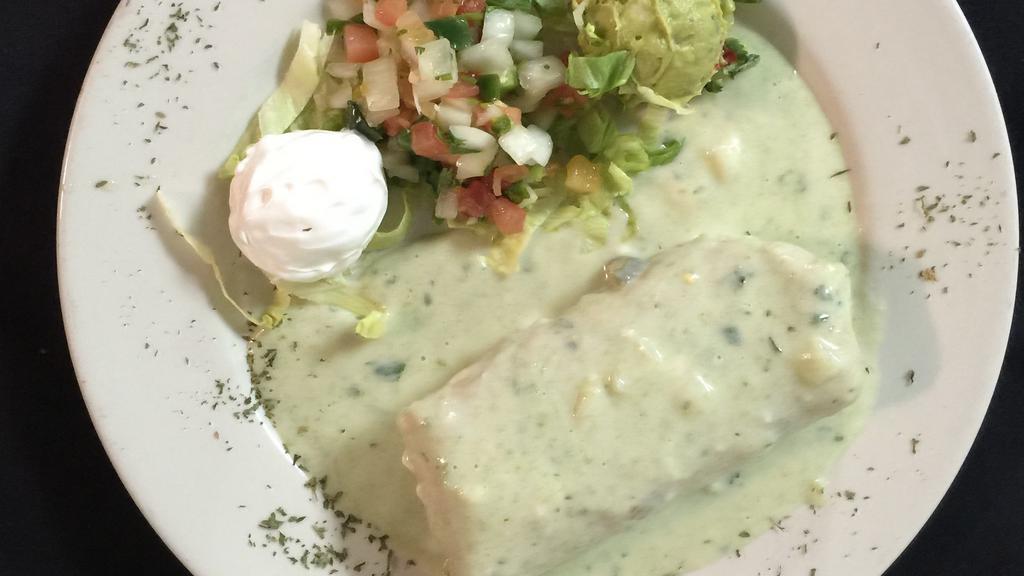 Chimichanga From The Grill · A large flour tortilla filled with beef or chicken fajita meat, cheese, poblano peppers & onions; golden fried & topped with green queso sauce. Pico de gallo, guacamole and sour cream.
