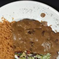 Carnitas Con Chipotle · Slow roasted pork tenders with a mild chipotle sauce. Mexican rice, house salad & borracho b...