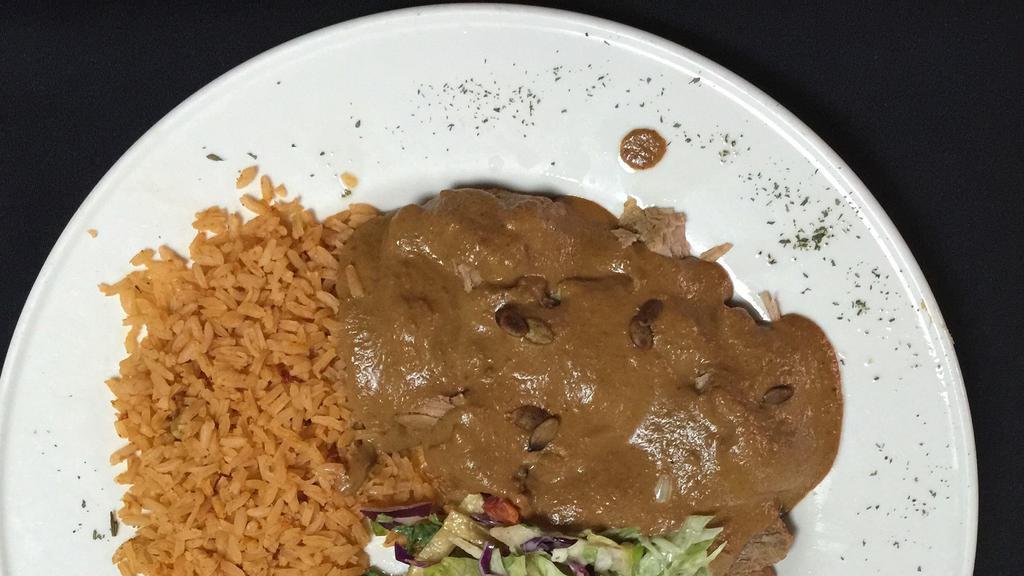 Carnitas Con Chipotle · Slow roasted pork tenders with a mild chipotle sauce. Mexican rice, house salad & borracho beans.