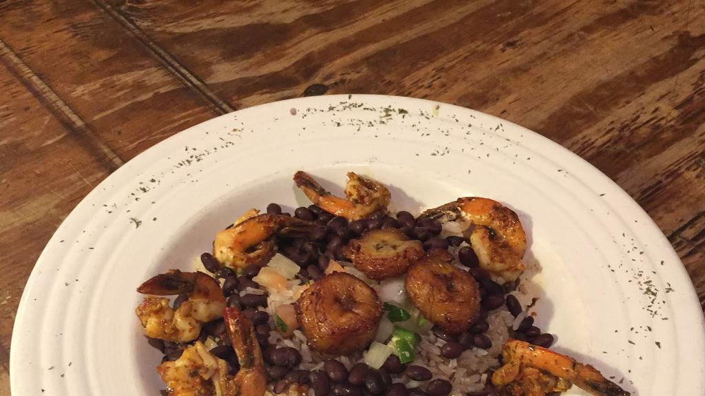 Moros Con Cristianos · Garlic sautéed jumbo shrimp atop a mix of white rice & black beans topped with fried plantains sprinkled with pico de gallo.