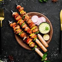 Chicken Tikka · Succulent morsels of chicken, marinated in tandoori masala and yogurt, cooked in an Indian c...