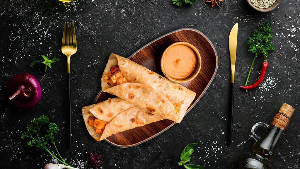 Spiced Cottage Cheese Tikka Roll · Soft cubes of our house spiced char grilled cottage cheese, and our signature house salad wrapped to perfection in a  soft naan bread 	with a spicy mint and cilantro dip
