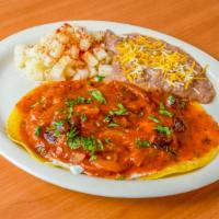 Huevos Rancheros · 2 over easy eggs on top of 2 corn tortillas topped with our Ranchero sauce and cilantro. Ser...