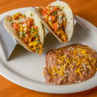 Tacos · Two tacos, soft or crispy, served with rice and beans.