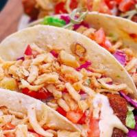 Fish Tacos · Three fish tacos filled w/ delicious breaded fish, shredded red cabbage, and special creamy ...