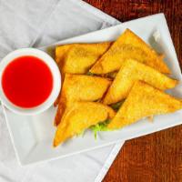 Crab Rangoons · Crispy wonton filled with cream cheese, onion and crab with sweet and sour sauce.