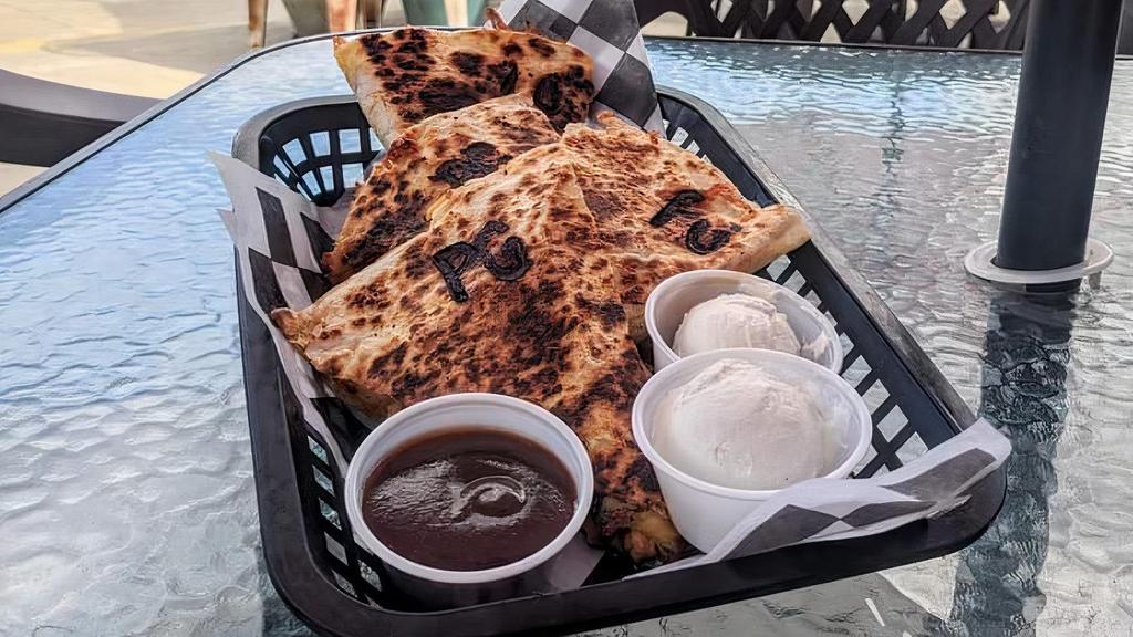 Blackened Chicken Quesadilla · Diced blackened chicken, sautéed bell peppers and onions with cheddar jack cheese in a toasted tortilla. Served with sour cream and salsa.