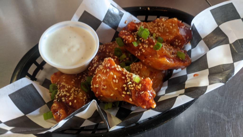 Wings - 1/2 Order · Five wings tossed in your favorite sauce. Your choice of sauce. (Sweet pepper Thai, BBQ, Lemon Pepper, Buffalo style, Mango Habanero or Bulgolgi).