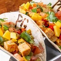 Blackened Tofu Tacos · Vegan. Diced blackened tofu sautéed with bell peppers and onions with lettuce and topped wit...