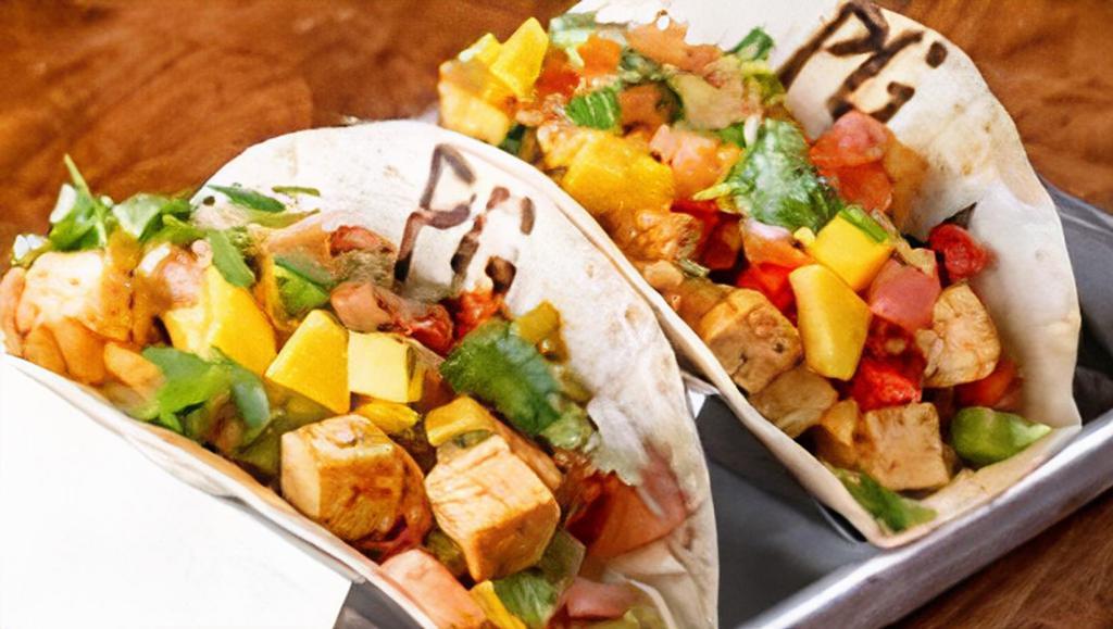 Blackened Tofu Tacos · Vegan. Diced blackened tofu sautéed with bell peppers and onions with lettuce and topped with mango pico.