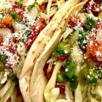 Grilled Chicken Tacos · Two tacos in flour or handmade corn tortillas with lettuce, shredded white cheese, tomato, a...
