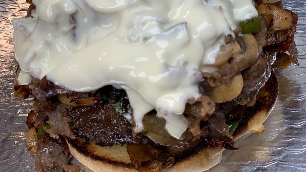 Philly Cheese Steak Burger · Half pound black Angus beef patty and four ounces of thin sliced sirloin steak served on a toasted  bun topped with grilled onions, mushrooms, bell pepper, and white American cheese.