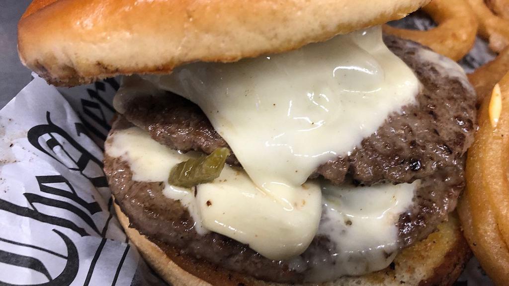 Spicy Pepper Jack Burger · Half pound black Angus beef patty served on a toasted bun topped with grilled jalapeños, Pepperjack cheese and spicy mayo.