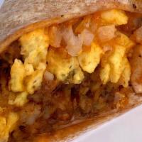 Breakfast Warp Wrap · An everything wheat tortilla stuffed with a crispy hash brown, JUST “egg” patty, house flavo...