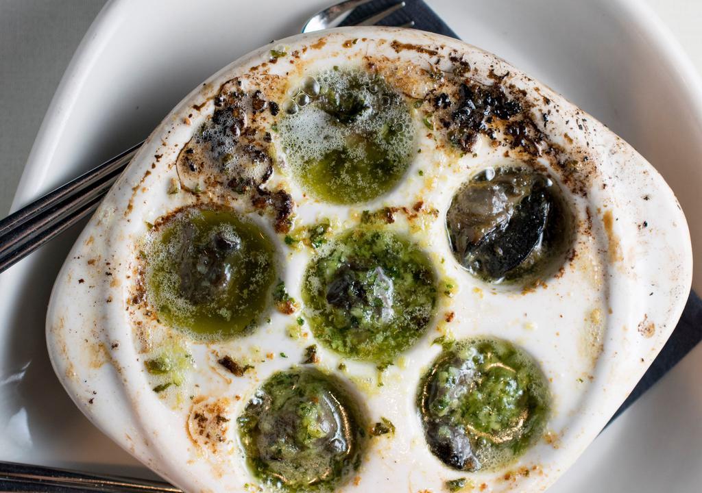 Escargot In Garlic Butter (Dinner Only) · Savory and succulent escargot in garlic infused melted butter .