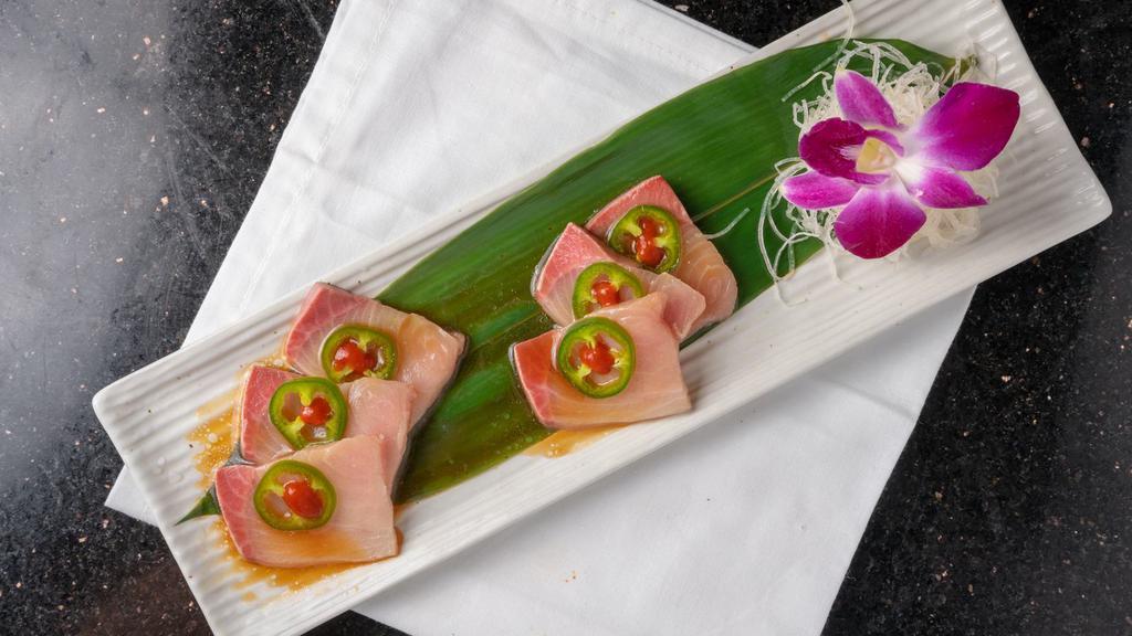 Yellowtail Heaven · 6 pcs of yellowtail sashimi served with jalapeno, green onion, spicy sriracha, and ponzu sauce.