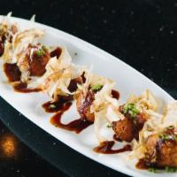 Takoyaki · 6 pcs of chopped octopus and vegetables made in balls marinated with house seasoning.