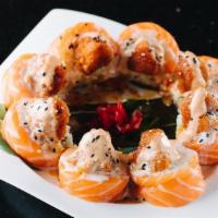 Red Mountain · Spicy. California roll wrapped with salmon topped with spicy tuna, served with house special...