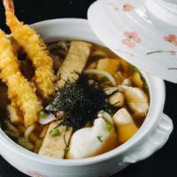 Nabeyaki Udon · Traditional Japanese noodle soup in a pot with chicken, cabbage, egg, and shrimp tempura.