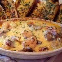 Crawfish Tail Fondue Cheese Rice · Comes with two slices of French garlic bread.