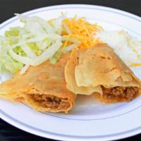 Ground Beef Pan Fried Taco · Pan fried taco with ground beef, lettuce, Cheddar cheese and Cotija cheese.