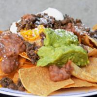 Nachos Supreme · Chips topped with your choice of meat, beans, guacamole, sour cream, cheese and Cotija cheese.