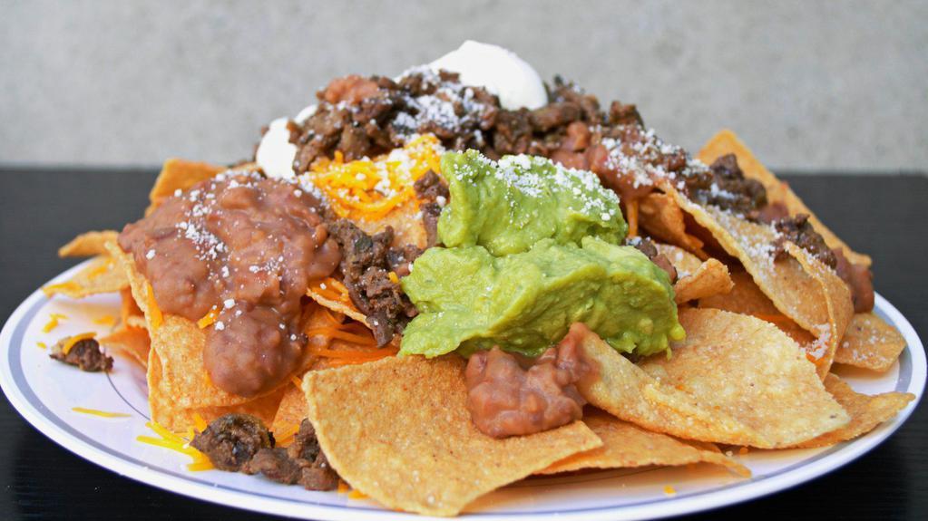 Nachos Supreme · Chips topped with your choice of meat, beans, guacamole, sour cream, cheese and Cotija cheese.