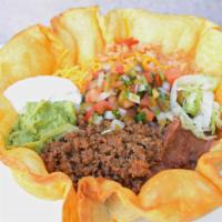 Deluxe Taco Salad · Deep fried tortilla filled with rice, refried beans, lettuce, Cheddar cheese, sour cream, gu...