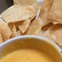 Chile Con Queso · Gluten-free. Melted queso cheese folded with house salsa, served with chips.