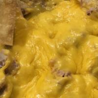 Super Nachos · Gluten-free. Ground beef or chicken on tortilla chips with refried beans, melted cheese, jal...