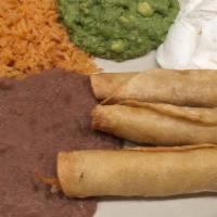 Chicken Flautas · Gluten-free. Three corn tortillas filled with shredded chicken and deep fried, served with g...