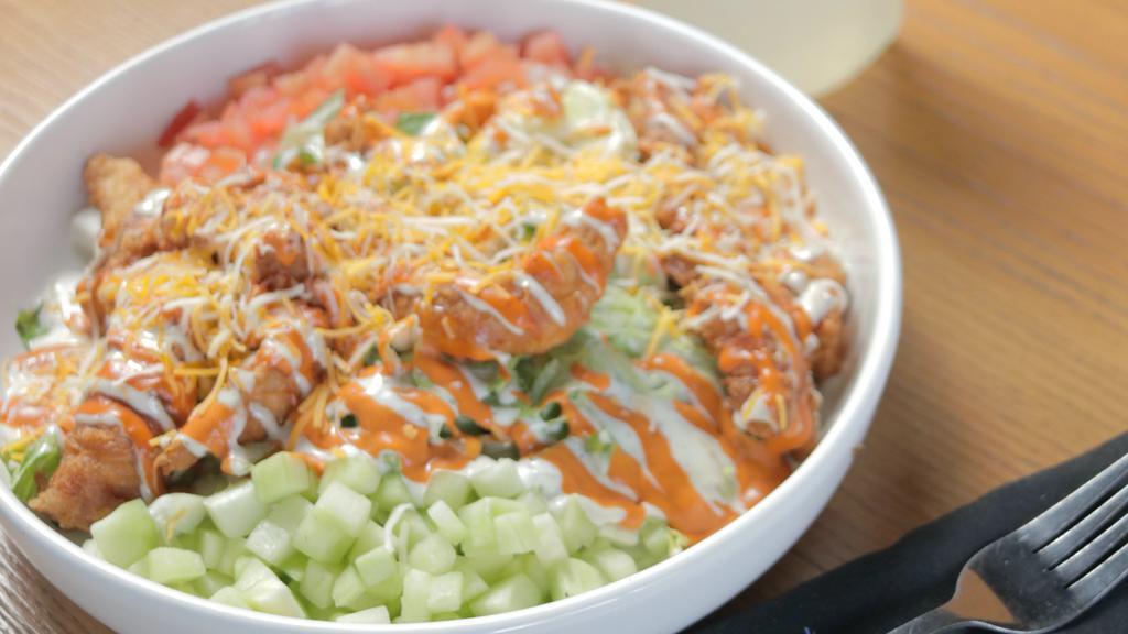 Buffalo Salad · Iceberg and Romaine lettuce topped with Buffalo Chicken Strips, cucumber, tomato, cheese mix and Ranch Dressing