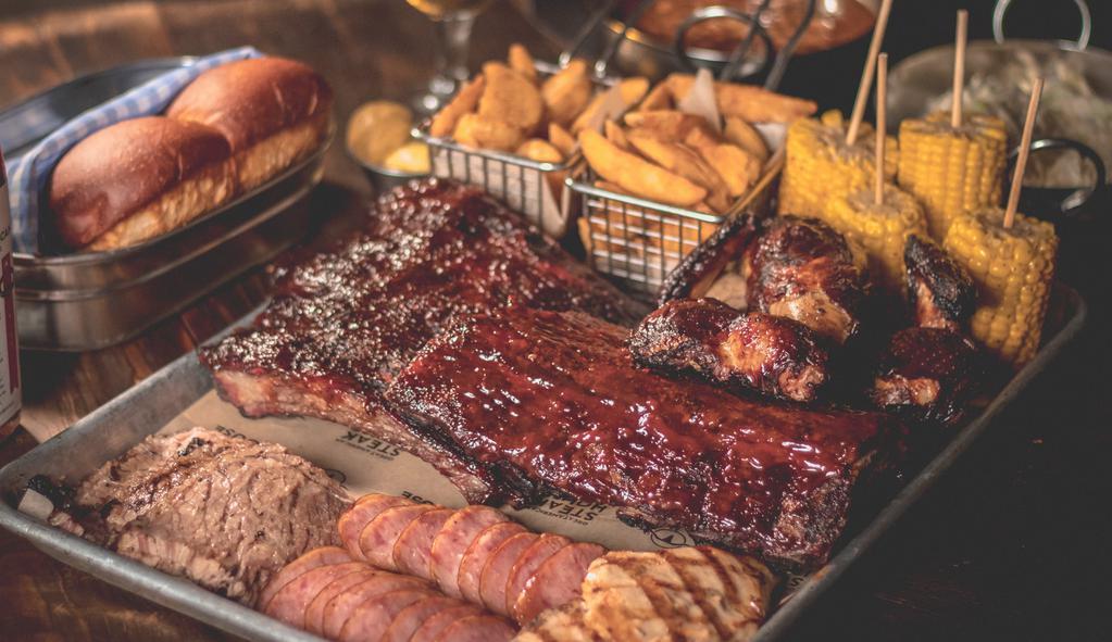 Full Bbq Tray (4-5 People) · Baby Back Ribs, pulled pork,Chicken, Brisket, Sausage, Steakfries, Corn on the Cob and Corn Bread