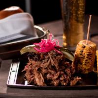 Brisket Platter · 12 oz. Includes pineapple coleslaw, beans, a dinner roll, and your choice of one side.
