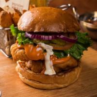 Buffalo Chicken Sandwich · Two pieces of beer battered chicken breasts tossed in spicy Buffalo sauce and served with ra...