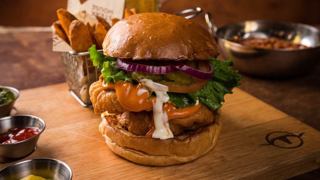 Buffalo Chicken Sandwich · Two pieces of beer battered chicken breasts tossed in spicy Buffalo sauce and served with ranch dressing. Made from a selected blend of prime cuts. Served with steak fries, lettuce, tomatoes, onions, and pickles.