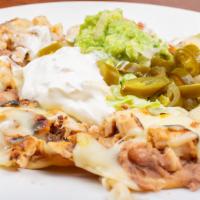 Fajita Nachos · Topped with fajita meat, refried beans and Cheddar cheese. Served with guacamole, sour cream...