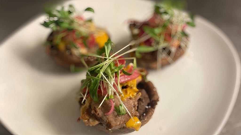 Chef George'S Sopes · Fried potato masa cakes topped with black beans, Carnitas or Short Rib, spicy almond sauce, pickled onions, queso fresco and micro cilantro.