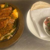 Marinated Skirt Steak · Served with black beans & Maria's rice, guacamole, pico de gallo, and house-made tortillas.