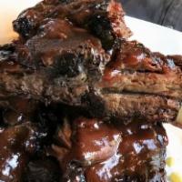 Bbq Beef Ribs · Slow roasted and brushed with ancho BBQ sauce.
