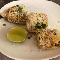 Mexican Corn · Charred, whole corn cob, slathered with mayo, sour cream, butter, cotija cheese and a blend ...