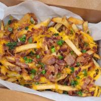 Cheese Fries · HANDCUT FRIES TOPPED WITH CHEDDAR CHEESE, BACON BITS, QUESO AND GREEN ONIONS