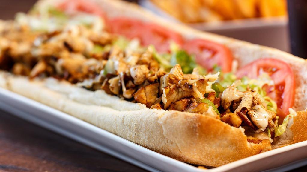 The Bbq Chicken Sub · Sweet tangy BBQ sauce smothered on crispy chicken tenders, diced onions, banana peppers and customer's choice of cheese on a Sub.