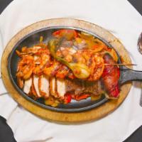 Parrillada Camaron/Fajita/Pollo · Shrimp chicken, beef fajitas blended with peppers and onions. Served with rice & beans.