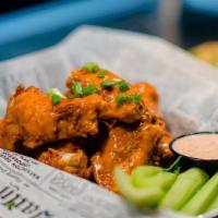 Chicken Wings · 10 bone in wings served with celery plus either bleu cheese or ranch dressing, tossed in you...