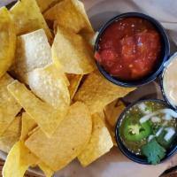 Trio Dips And Chips · Tortilla chips with warm queso cheese dip, salsa and house guacamole.