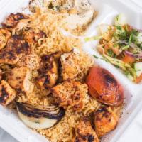 Chicken Tikka · 2 Skewers of marinated chicken tinder pieces grilled over charcoal.