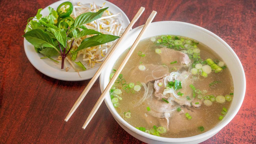 Eye-Round Steak & Flank (Tái & Nạm) · Medium rare beef. Choice of traditional beef or vegetable broth. Served with rice noodles, green onions, yellow onions, cilantro, basil, lime, jalapeno peppers and bean sprouts.