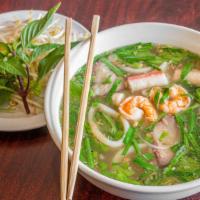 Pork & Seafood Noodle Soup (Hủ Tiếu Thập Cẩm) · served crab, pork and shrimp with egg noodles, cilantro, jalapeno peppers and bean sprouts.