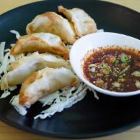 Mandoo · chicken and vegetable dumpling, fried, soy dipping sauce on the side
